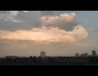 Time lapse of moving clouds over city