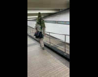 Collab Subway Creatures - Man wear plants on head while walking on subway station