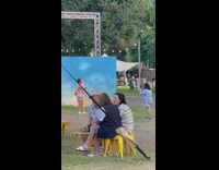 Woman blue jacket dance beside blue wall
