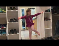 Young girl climb between shoe shelves dad