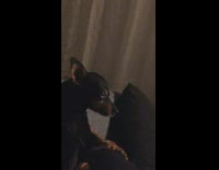 Guy sits on couch with crying dog 