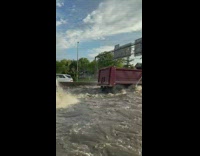 Two Big Trucks Pass Through Flooded Expressway