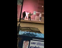 Woman white sleeves hold bag brick wall