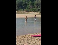 Girl runs lake water white shorts guy