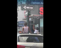 Man doing pull ups on traffic light 