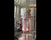 Pt. 2 Woman in Donald trump mask and pink baby diaper costume walks around subway train