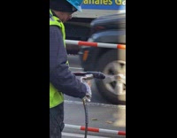 Construction guy torching a wire that looks phallic