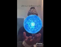 Guy opens fist reveals blue sphere ball