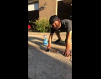 Guy scrubs skid marks ground red car 