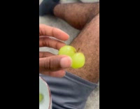 Guy show two green grape fused together
