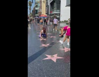 Woman in white crop top tiktok dance walk of fame