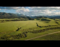 Drone hyper lapse of green fields and mountains