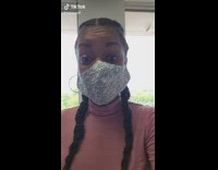 Lady shows face mask pattern up close 