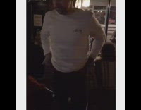 Guy takes a sip of beer at a pub and starts doing Irish dance to Irish music