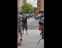Man pushes girl on skateboard with AC unit