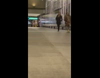 Woman in black outfit poses on the tunnel walkway