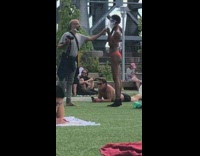 Girl orange bikini face mask crowded park