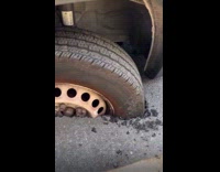 Van tires sink on broken road