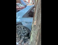Tequila bottle on top of burnt car