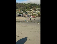 Black wetsuit girl white surfboard camera tripod 