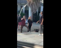 Woman black top photo shoot sidewalk signage