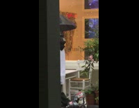 Person walks with TV head and umbrella 