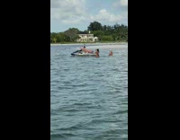 Woman pink bikini lie down jet skit photo shoot