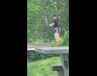 Collab IITW - Woman in black shirt exercise dance with tripod at the river