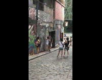 Girl and couple take picture in front of art mural wall