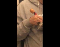 man in grey with a trump bobble head pen