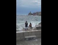 Man and woman barrier large beach waves Part 2