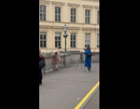 Woman raises foot with bag for photo