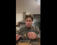 Guy in grey sweater eating seaweed wrap with fork