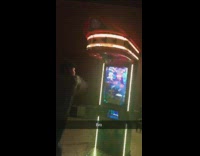 Guy outside at punching bag arcade game breaks machine