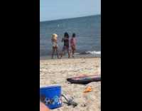 Woman pink bikini bend over at beach