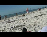girl in pink break dances on beach