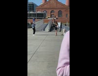 Girl black dress grey metal bridge sunny