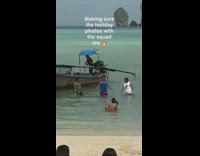 three men hold hands boat water