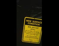 Sign says anti slip but guy slides across bridge on shoes