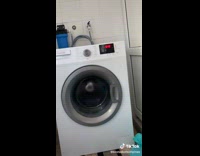 Guy puts white substance on card washing machine spins