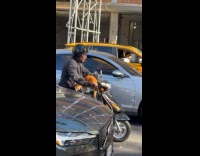 Man drive scooter motorcycle with orange cat