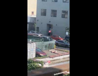 Man sunbathing at parking lot hotel