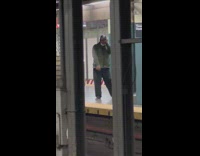 Man on subway train platform singing song loudly