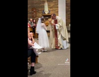 Girl first communion drinks up wine chalice