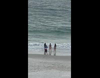 Red white sweater guy three bikini girls 