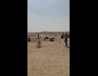 Woman in white dress dances with a scarf by the pyramids