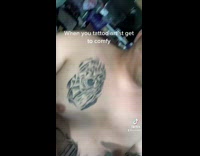 Tattoo artist leans over on clients face 