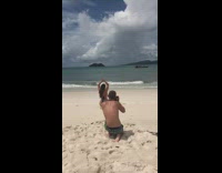 Woman checkered bikini butt pose beach