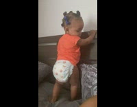 Baby in diapers pooping into diaper