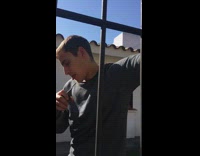 drunk man singing and banging head on gate